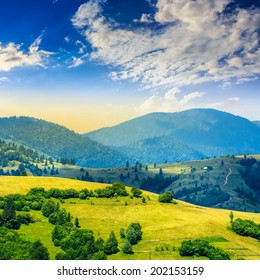 Стоковая фотография: summer landscape. village on the hillside. forest on the mountain light fall on clearing on mountains