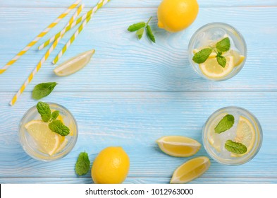 Summer Lemonade. Cold Refreshing Summer Drink With Lemon And Mint On Light Blue Wooden Background, Top View, Flat Lay, Copy Space.