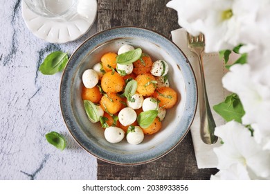 Summer Light Food. Mozzarella And Melon Salad With Basil. Top View