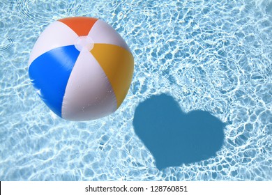 Summer Love, Beach Ball On The Swimming Pool With Heart Shaped Shadow