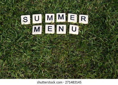 Summer Menu Written In Tiles On Green Grass