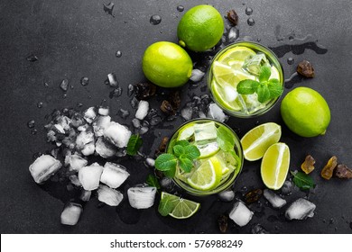 Summer Mint Lime Refreshing Cocktail Mojito With Rum And Ice In Glass On Black Background Top View