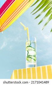 Summer Mood. Bottom View Of Glass With Fresh Refreshment Over Blue Sunny Sky Background. Vacation, Happiness, Summer Vibes. Retro Vintage Style, Cinematic Photo. Tropical Climate