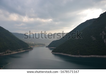 Summer mountain landscape of Lake Piva (Pivsko jezero), a reservoir in the northwest part of the Montenegro, Pluzine municipality. View from the panoramic road P14 leading to Durmitor Mountains.