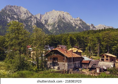Summer mountain landscape with remote small village in the valley of Bucegi mountains, Busteni, Prahova county, Romania.