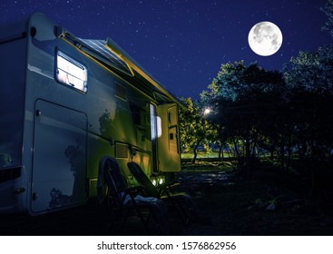 Summer Night RV Camping. Recreational Vehicle Class C Motorhome Under Starry Sky. Campground RV Park Pitch. Modern Camper Van.