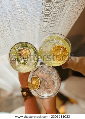 Summer nights with friends, refreshing drinks with lime and orange slices with a soft boho backround