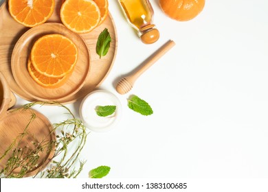 summer orange fruit citrus with wood dinner dish and cosmetic spa lotion facial cream for skin care, ingedients of food and healthy, oil extract herb natural, top view, nutrition of vitamin c