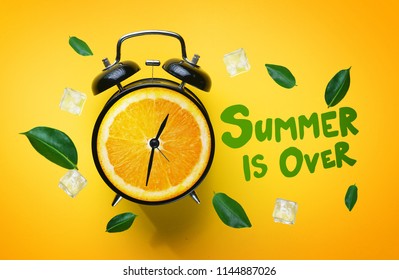 Summer is Over Typography. Alarm Clock of Orange Fruit Green Leaves and Ice Cube Flying Around on Yellow Background