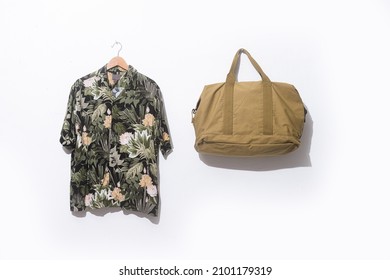 Summer palm leaf ,flower pattern shirt with short sleeves  with handbag on hanging  