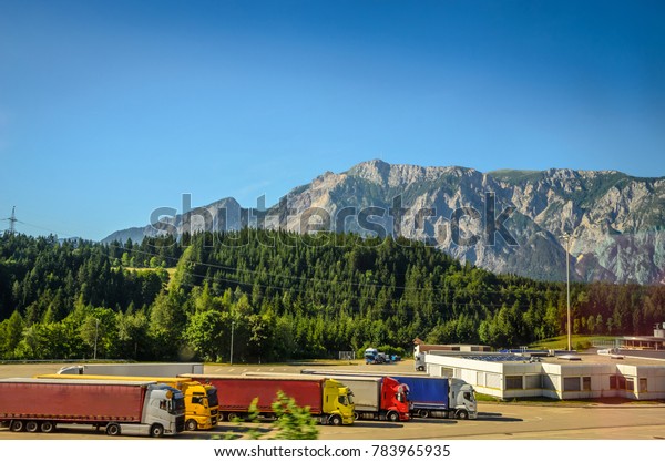 Summer\
panorama of Alps mountains with truck\
cars