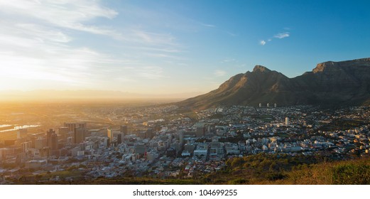 Summer panorama of dawn in the city on the background of the mountains (Cape Town, South Africa - Table Mountain)
