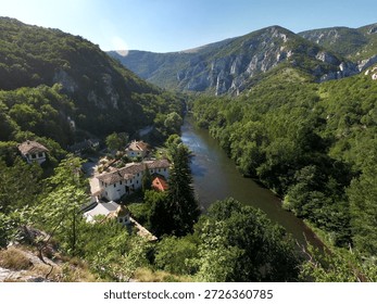 Summer panoramic view of Cherepish Monastery “Assumption of Mary” in Bulgaria, nestled in the Iskar Gorge beneath the Vratsa Balkan, surrounded by dramatic cliffs and river scenery, BG, 02 Aug. 2020