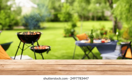 summer party in back garden with BBQ grill, wooden table, blurred background