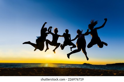 Summer Party People Jumping For Joy, Fun At Vibrant Sunset Sky