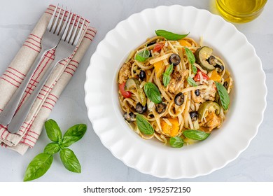 Summer Pasta With Bell Pepper, Zucchini, Olive And Chicken In A Bowl Top Down Photo