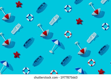 Summer Pattern Made With Beach Chair, Life Saver Float, Sun Umbrellas And Boats On Vibrant Blue Background. Creative Vacation Texture Concept. Trendy Minimal Sea Flat Lay Composition.