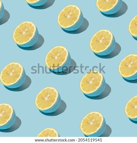 Summer pattern made with blue lemon slice on pastel blue background. Minimal style. Food concept.