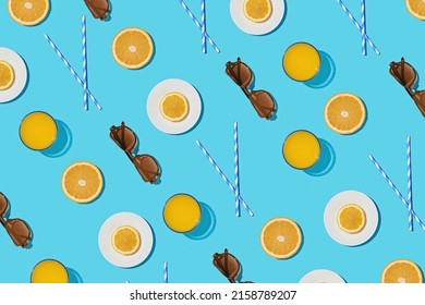Summer pattern on a bright blue pastel background sunlight fruity orange and sunglasses. Minimal trend summer concept.