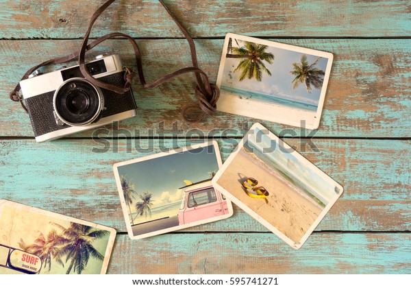 Summer photo album of journey in summer surfing\
beach trip on wood table. instant photo of vintage film camera -\
vintage and retro style