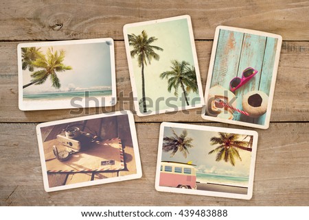 Summer photo album of remembrance and nostalgia on wood table. Photography from beach vacation. instant photo camera - vintage postcards and retro styles