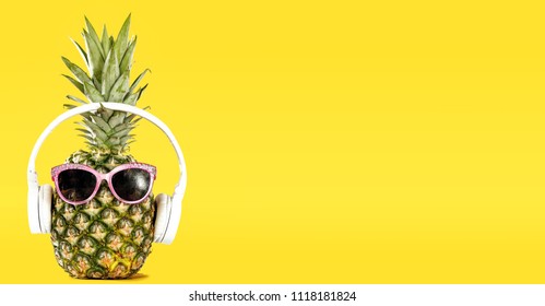Summer photo of pineapple and yellow background. Free space for your text. 