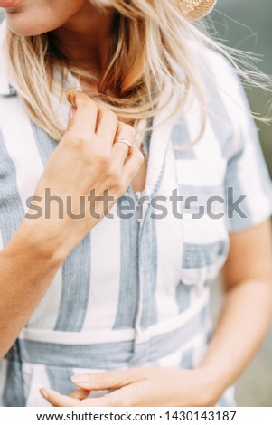 Similar – Frau mit Jeansjacke, blauer Bluse und silberner Armbanduhr.