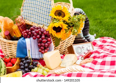 Summer Picnic With A Basket Of Food In The Park.