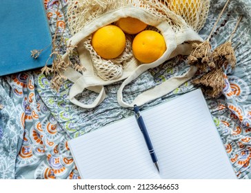 Summer Picnic Flatlay, Fruits, Oranges In String Bag, Notes And Laptop On Cotton Blanket, Freelance Work, Outdoor Office. High Quality Photo