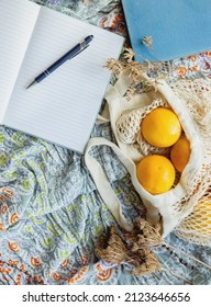 Summer Picnic Flatlay, Fruits, Oranges In String Bag, Notes And Laptop On Cotton Blanket, Freelance Work, Outdoor Office. High Quality Photo