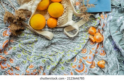 Summer Picnic Flatlay, Fruits, Oranges In String Bag, Notes And Laptop On Cotton Blanket, Freelance Work, Outdoor Office. High Quality Photo