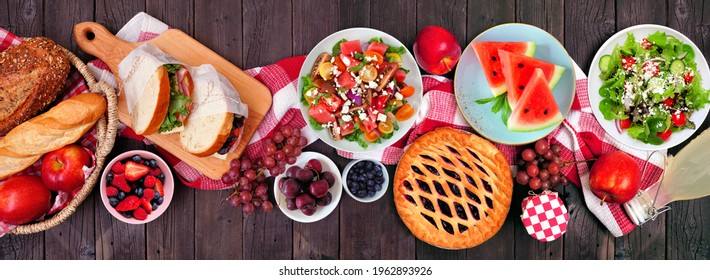 Summer Picnic Food Table Scene Overhead View On A Wood Banner Background. Variety Of Cold Salads, Sandwiches, Fruit And Treats.