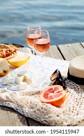 Summer Picnic On The Beach. Glasses Of Rose Wine, Camamber Cheese, Fruits, Croissants.