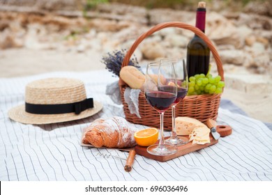Summer Picnic on the beach at sunset in the white plaid, food and drink conception.