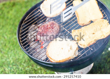 Summer picnic with small charcoal grill in the park.