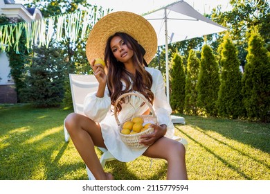 Summer portrait of an attractive dark-skinned girl in a hat. Beautiful African American Woman in Straw Hat.                         - Shutterstock ID 2115779594