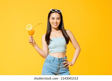 Summer Portrait Of Beautiful Asian Woman Holding Fruit Juice Drink In Isolated Studio Yellow Color Background