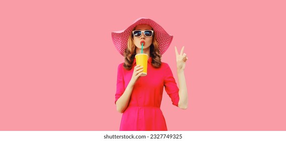 Summer portrait of beautiful young woman drinking fresh juice wearing straw hat, pink dress on background - Powered by Shutterstock