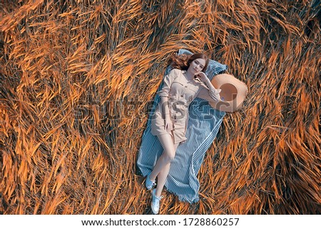 Similar – beautiful young woman siiting outdoors in forest, dreaming with closed eyes in serene pose