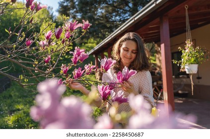 Summer portrait, happy young woman enjoying nature in garden sitting on chair - Powered by Shutterstock