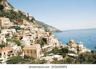 summer in positano, flowers, pebble beach, buildings carved into the mountains, la dolce vita, boats in the bright blue ocean, no people visible