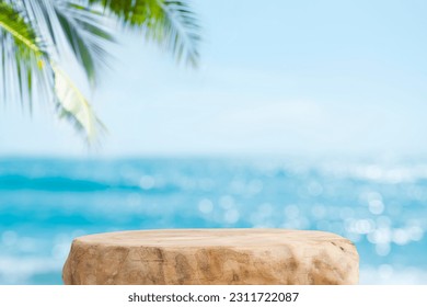 Summer product display on wooden podium at sea tropical beach - Shutterstock ID 2311722087