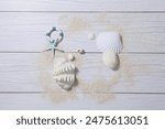 a summer props and sand against a light white wood background. top view. An empty space for display cosmetic products, food and props.