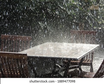 Summer rain hitting patio furniture - Powered by Shutterstock