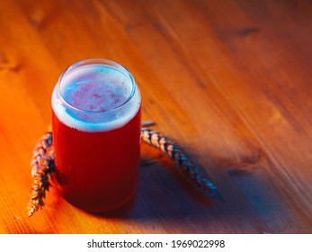 Summer Red Fruit Craft Beer Sour Ale. Stylish Glass In The Form Of A Can Of Beer. Wooden Table