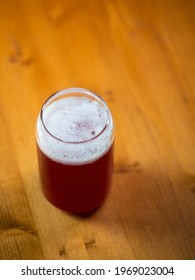 Summer Red Fruit Craft Beer Sour Ale. Stylish Glass In The Form Of A Can Of Beer. Wooden Table