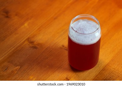 Summer Red Fruit Craft Beer Sour Ale. Stylish Glass In The Form Of A Can Of Beer. Wooden Table