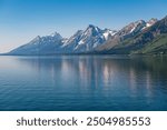 Summer reflection of Grand Teton Mountain Range with snow, Jackson Lake, Grand Teton National Park, Wyoming, United States of America (USA).