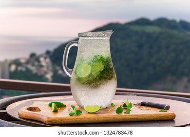 Summer Refreshing Cocktail With Lime And Mint In A Jug On The Terrace