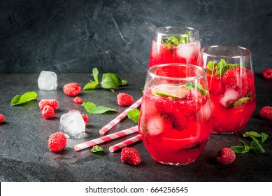 Summer refreshing non-alcoholic cocktails. Fruit drinks. Raspberry mojito lemonade with fresh organic mint and lime. On a black stone table. Copy space  - Shutterstock ID 664256545